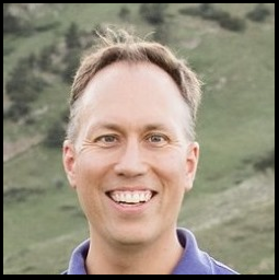 Head shot of Dr. Jonathan Vigh with backdrop of the Flatirons